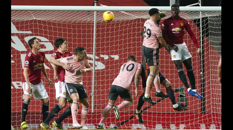Sheffield Uniteds Kean Bryan (second from right) scores his team's first goal against Sheffield United during their English Premier League match at Old Trafford in Manchester on Wednesday. -- AP Sheffield Uniteds Kean Bryan (second from right) scores his team's first goal against Sheffield United during their English Premier League match at Old Trafford in Manchester on Wednesday. -- AP