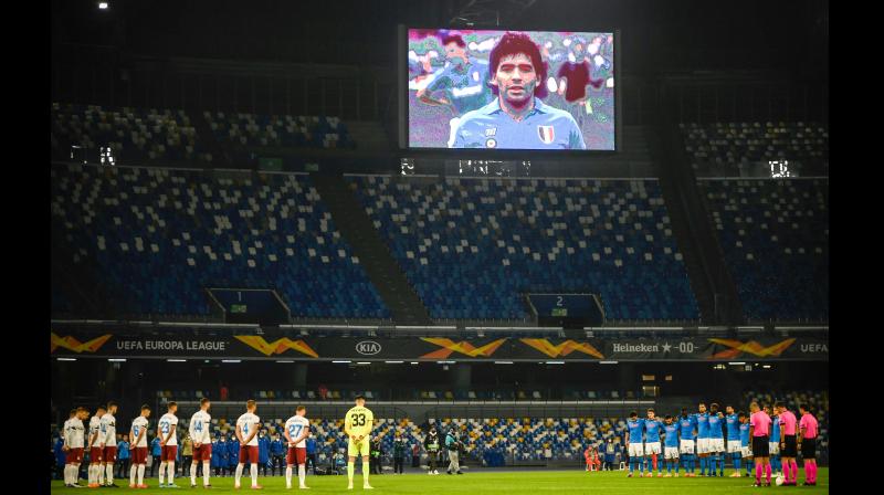 Players of Napoli (in blue) and Rijeka observe a minute’s silence in homage to Maradona prior to their Europa League match at the San Paolo stadium in Naples on Thursday as a screen displays a photo of late Argentinian legend, who had played for Napoli in the 1980s. — AFP Players of Napoli (in blue) and Rijeka observe a minute’s silence in homage to Maradona prior to their Europa League match at the San Paolo stadium in Naples on Thursday as a screen displays a photo of late Argentinian legend, who had played for Napoli in the 1980s. — AFP