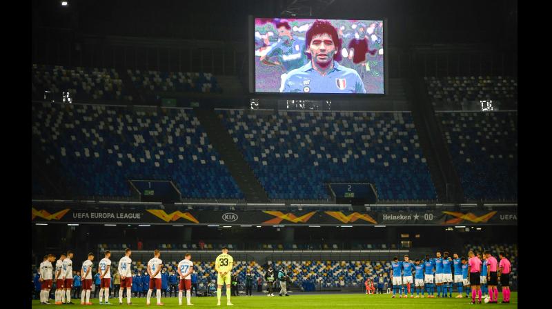 Players of Napoli (in blue) and Rijeka observe a minutes silence in homage to Maradona prior to their Europa League match at the San Paolo stadium in Naples on Thursday as a screen displays a photo of late Argentinian legend, who had played for Napoli in the 1980s.	 AFP