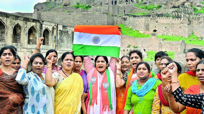 Members of the Telangana BJP state Mahila Morcha hold aloft the Tricolour and raise slogans at the Golkonda Fort after the police denied them permission to hold a rally to mark Hyderabad Liberation Day, on Tuesday. (Photo: P. Surendra) Members of the Telangana BJP state Mahila Morcha hold aloft the Tricolour and raise slogans at the Golkonda Fort after the police denied them permission to hold a rally to mark Hyderabad Liberation Day, on Tuesday. (Photo: P. Surendra)