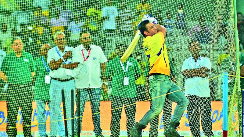 M.S. Dhoni, sporting a yellow jersey, takes part in the ‘six-hitting’ competition that kick started the second edition of the Tamil Nadu Premier League on Saturday. Former BCCI president, N. Srinivasan looks on from behind. (Photo: E.K. Sanjay) M.S. Dhoni, sporting a yellow jersey, takes part in the ‘six-hitting’ competition that kick started the second edition of the Tamil Nadu Premier League on Saturday. Former BCCI president, N. Srinivasan looks on from behind. (Photo: E.K. Sanjay)