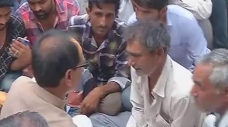 Madhya Pradesh Chief Minister Shivraj Singh Chouhan meets family members of farmers killed in Mandsaur protest. (Photo: ANI | Twitter) Madhya Pradesh Chief Minister Shivraj Singh Chouhan meets family members of farmers killed in Mandsaur protest. (Photo: ANI | Twitter)
