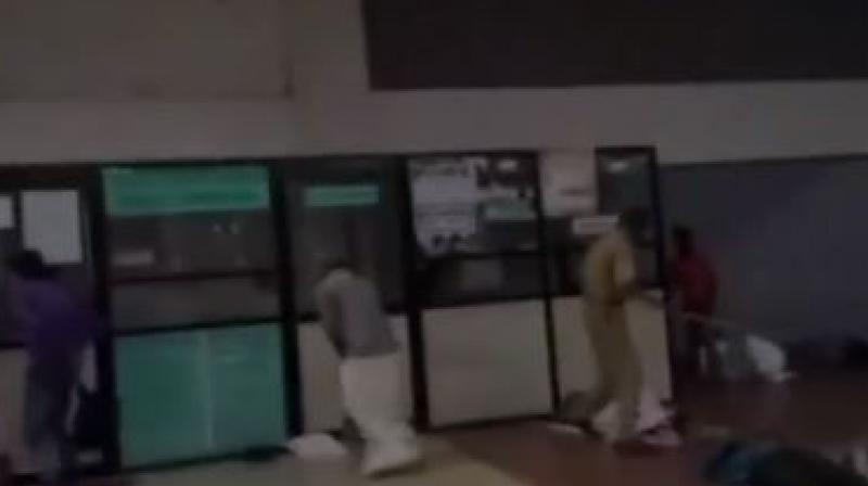 A security guard was caught caning sleeping passengers at a bus terminal on Tuesday at Thiruvananthapuram's Thampanoor. (Photo: Screengrab) A security guard was caught caning sleeping passengers at a bus terminal on Tuesday at Thiruvananthapuram's Thampanoor. (Photo: Screengrab)