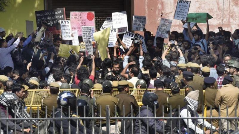 Policemen guard as All India Students Association (AISA) and Jawaharlal Nehru University students hold a protest demanding the arrest of Akhil Bharatiya Vidyarthi Parishad (ABVP) members at the police headquarters in New Delhi. (Photo: File/PTI) Policemen guard as All India Students Association (AISA) and Jawaharlal Nehru University students hold a protest demanding the arrest of Akhil Bharatiya Vidyarthi Parishad (ABVP) members at the police headquarters in New Delhi. (Photo: File/PTI)