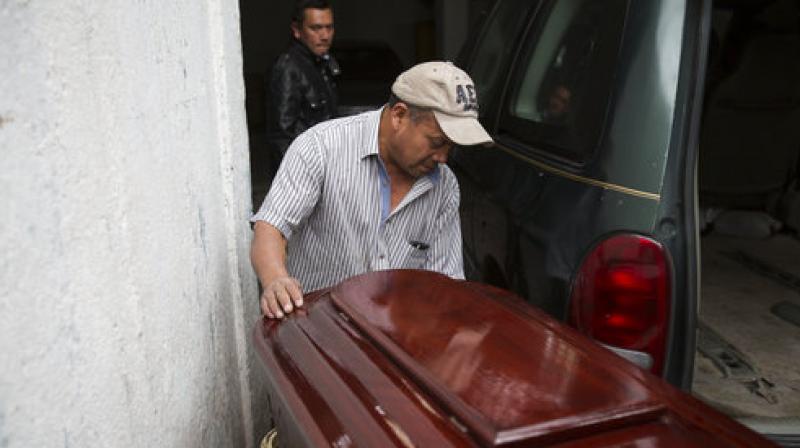 A man pushes the coffin of Keila Salguero, a victim of the Virgin of the Assumption Safe Home fire, at the morgue in Guatemala City. (Photo: AP) A man pushes the coffin of Keila Salguero, a victim of the Virgin of the Assumption Safe Home fire, at the morgue in Guatemala City. (Photo: AP)