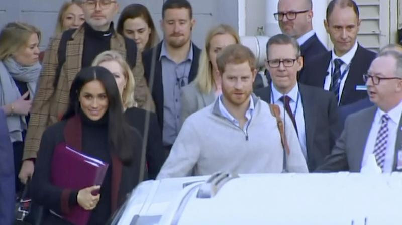 In this image made from video, Britain's Prince Harry, center right, and his wife Meghan, center left, Duke and Duchess of Sussex, approach a car at an airport in Sydney, Monday, Oct. 15, 2018. (Photo: AP) In this image made from video, Britain's Prince Harry, center right, and his wife Meghan, center left, Duke and Duchess of Sussex, approach a car at an airport in Sydney, Monday, Oct. 15, 2018. (Photo: AP)