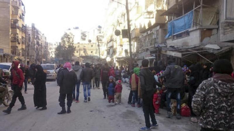 A slow-moving convoy of around two dozen vehicles snaked out of Al-Amiriyah district and crossed into government-held Ramussa en route to rebel-held territory in the west of Aleppo province. (Photo: AP) A slow-moving convoy of around two dozen vehicles snaked out of Al-Amiriyah district and crossed into government-held Ramussa en route to rebel-held territory in the west of Aleppo province. (Photo: AP)