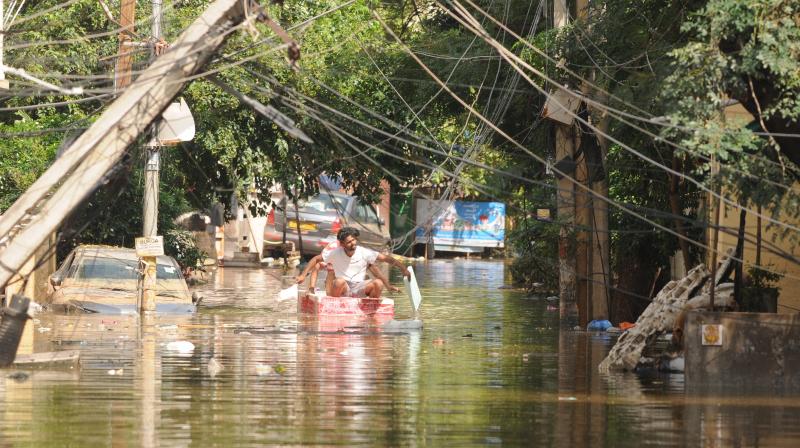 GHMC workers move colony people of Ramanthapur with boats as heavy flooded water has been still in the colonies.  Deepak Deshpande photo