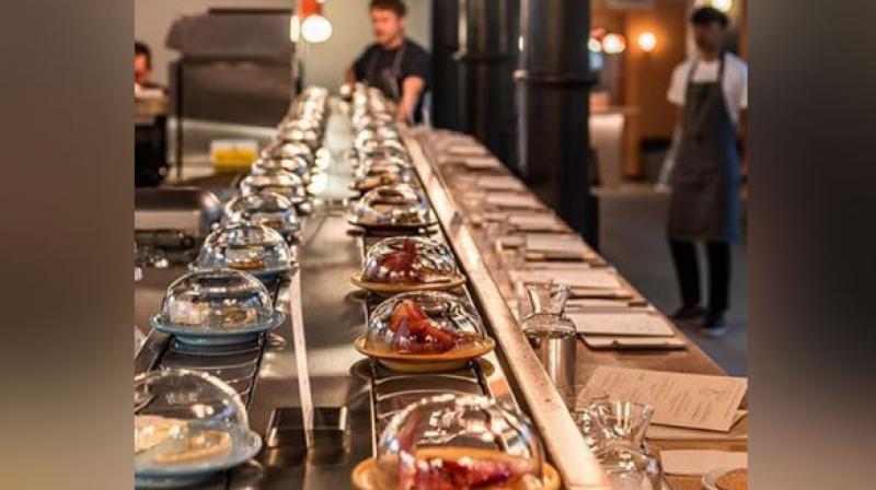A new restaurant in London is making sure that its customers get to hog on their favourite type of cheese and that too on a conveyer belt. (Photo: ANI) A new restaurant in London is making sure that its customers get to hog on their favourite type of cheese and that too on a conveyer belt. (Photo: ANI)