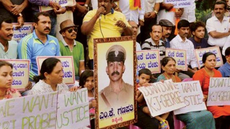 A file photograph of a protest soon after the suicide of DYSP M.K. Ganapathi demanding a fair and impartial probe into the incident A file photograph of a protest soon after the suicide of DYSP M.K. Ganapathi demanding a fair and impartial probe into the incident