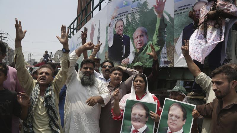 Supporters of Pakistani former prime minister Nawaz Sharif chant slogans for their leader in Lahore, Pakistan on Friday. (Photo: AP) Supporters of Pakistani former prime minister Nawaz Sharif chant slogans for their leader in Lahore, Pakistan on Friday. (Photo: AP)