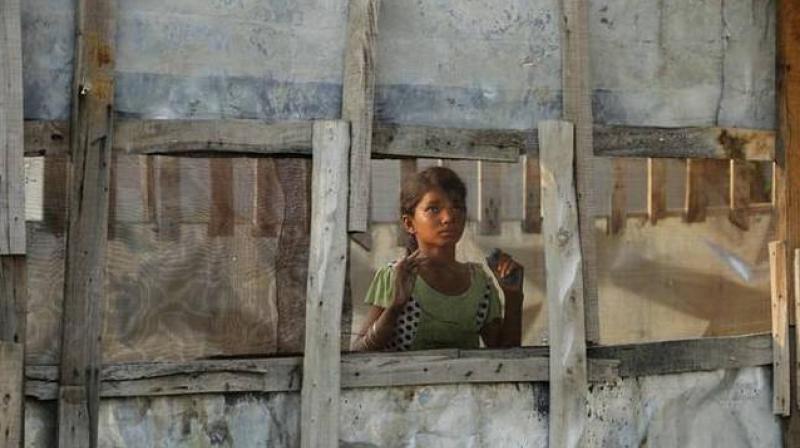 In this August 16, 2017 photo, a Rohingya refugee girl looks through a mesh window at a camp set up for the refugees on the outskirts of Jammu. (Photo: AP) In this August 16, 2017 photo, a Rohingya refugee girl looks through a mesh window at a camp set up for the refugees on the outskirts of Jammu. (Photo: AP)