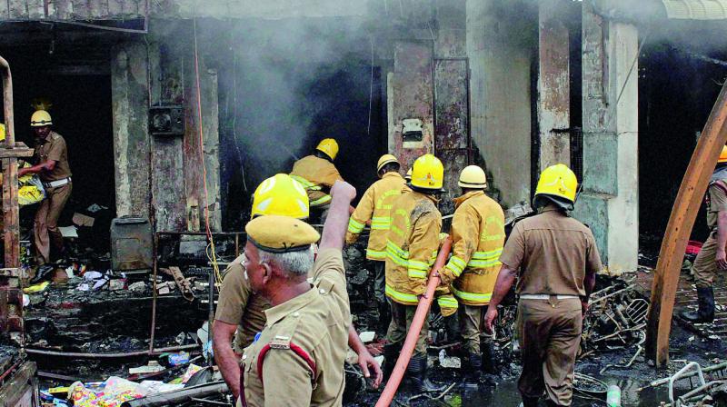 Fire fighters trying to douse flames after a godown caught fire in Sivakasi in Tamil Nadu. (Photo: PTI) Fire fighters trying to douse flames after a godown caught fire in Sivakasi in Tamil Nadu. (Photo: PTI)
