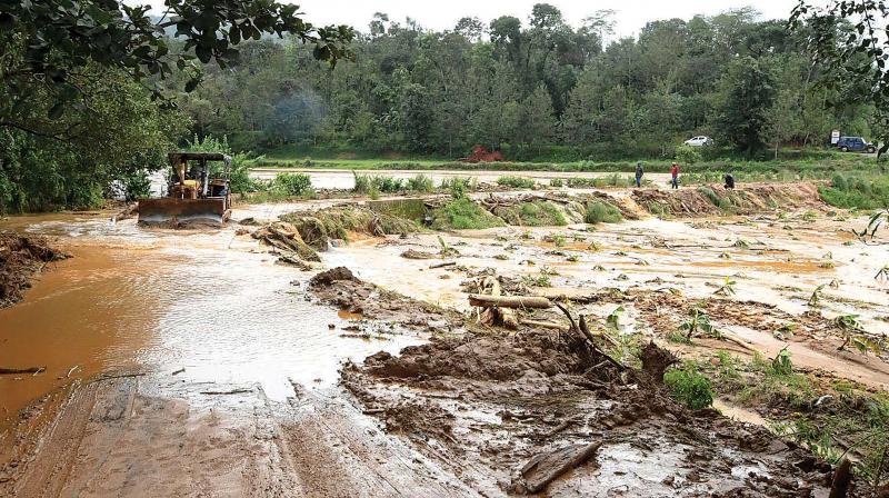 A road in the flood-hit Madapur village of Kodagu district. A road in the flood-hit Madapur village of Kodagu district.