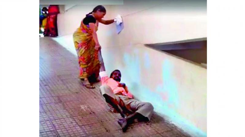 A video grab of P. Srinivasachari’s wife dragging him up the stairs of APVP Hospital in Guntakal. (Photo: DC) A video grab of P. Srinivasachari’s wife dragging him up the stairs of APVP Hospital in Guntakal. (Photo: DC)