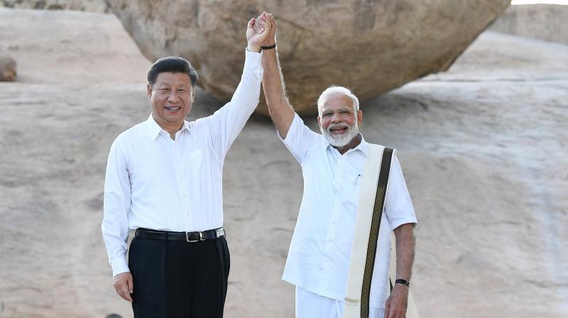 Chinese President Xi Jinping and Indian Prime Minister Narendra Modi raise hands together at Arjuna's Penance in Mamallapuram, India. (Photo: AP) Chinese President Xi Jinping and Indian Prime Minister Narendra Modi raise hands together at Arjuna's Penance in Mamallapuram, India. (Photo: AP)