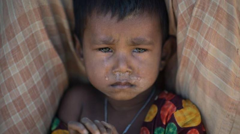 A Rohingya Muslim refugee child cries as she sits in the Kutupalong refugee camp in Cox's Bazar, Bangladesh, on Monday (Photo: AFP/ Representational) A Rohingya Muslim refugee child cries as she sits in the Kutupalong refugee camp in Cox's Bazar, Bangladesh, on Monday (Photo: AFP/ Representational)