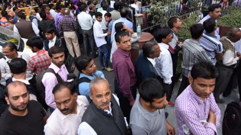 People standing in long queues to exchange their old Rs 500 and 1000 notes and withdraw cash from the ATM. (Representational Image/ PTI) People standing in long queues to exchange their old Rs 500 and 1000 notes and withdraw cash from the ATM. (Representational Image/ PTI)