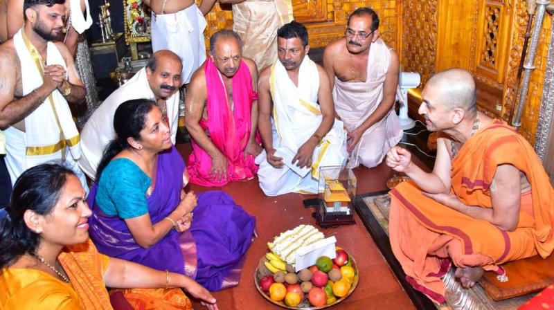 Palimaru mutt chief Paryaya Swami Vidyadeesha Teertha, handed over the 'prasadam' to her. (Image: ANI) Palimaru mutt chief Paryaya Swami Vidyadeesha Teertha, handed over the 'prasadam' to her. (Image: ANI)