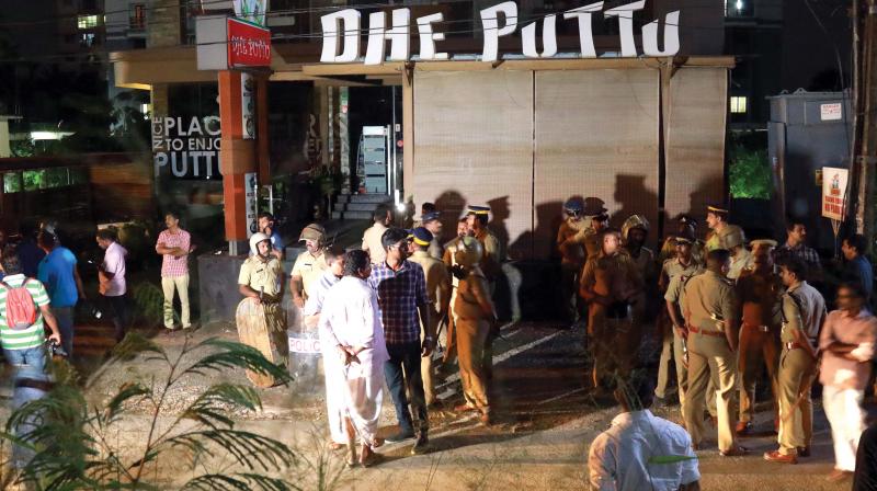 Police personnel and local residents near Dhe Puttu restaurant owned by actor Dileep in Kochi on Monday night. (Photo: ARUNCHANDRA BOSE) Police personnel and local residents near Dhe Puttu restaurant owned by actor Dileep in Kochi on Monday night. (Photo: ARUNCHANDRA BOSE)