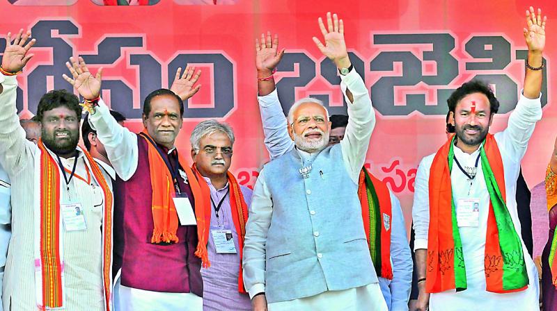 Prime Minister Narendra Modi during the Mahbubnagar rally with Kalwakurthy candidate, T. Achary BJP TS chief K. Lakshman, and BJP ex-MLA G. Kishan Reddy. — P Surendra Prime Minister Narendra Modi during the Mahbubnagar rally with Kalwakurthy candidate, T. Achary BJP TS chief K. Lakshman, and BJP ex-MLA G. Kishan Reddy. — P Surendra