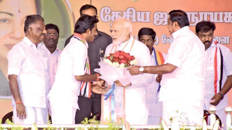 PM Narendra Modi being greeted by AIADMK candidate Ravindranath at a rally in Theni, as CM Edappadi K. Palaniswami and deputy CM O Panneerselvam look on. (DC) PM Narendra Modi being greeted by AIADMK candidate Ravindranath at a rally in Theni, as CM Edappadi K. Palaniswami and deputy CM O Panneerselvam look on. (DC)