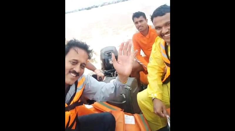 Maharashtra minister Girish Mahajan was seen smiling and waving in one of the videos during flood survey in Kolhapur, Maharashtra. (Photo: Twitter | @VinayMIRROR) Maharashtra minister Girish Mahajan was seen smiling and waving in one of the videos during flood survey in Kolhapur, Maharashtra. (Photo: Twitter | @VinayMIRROR)