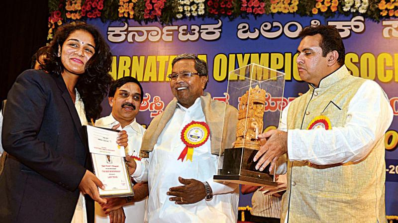CM Siddaramaiah presents Karnataka Olympic Association awards in Bengaluru on Monday. Minister for Sports and Youth Affairs Pramod Madhwaraj is seen. (Photo: KPN) CM Siddaramaiah presents Karnataka Olympic Association awards in Bengaluru on Monday. Minister for Sports and Youth Affairs Pramod Madhwaraj is seen. (Photo: KPN)