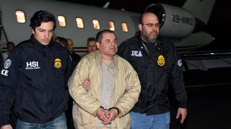 Authorities escort Joaquin 'El Chapo' Guzman from a plane to a waiting caravan of SUVs at Long Island MacArthur Airport on Thursday. (Photo: AP) Authorities escort Joaquin 'El Chapo' Guzman from a plane to a waiting caravan of SUVs at Long Island MacArthur Airport on Thursday. (Photo: AP)