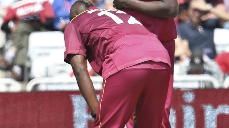 Hope delighted the crowd when he flew to his left to scoop up a one-handed grab that removed Usman Khawaja for 13 off the bowling of Andre Russell. (Photo:AP) Hope delighted the crowd when he flew to his left to scoop up a one-handed grab that removed Usman Khawaja for 13 off the bowling of Andre Russell. (Photo:AP)
