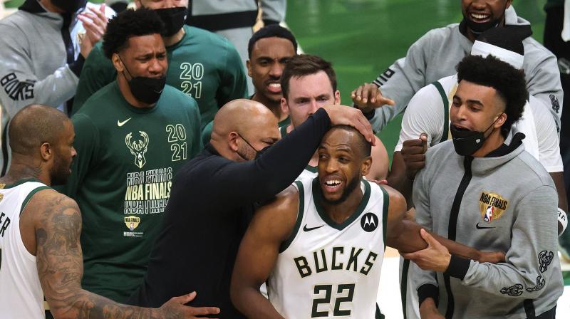 Khris Middleton of the Milwaukee Bucks is congratulated by teammates during the second half in Game Four of the NBA Finals against the Phoenix Suns at Fiserv Forum on July 14, 2021 in Milwaukee, Wisconsin.Khris Middleton #22 of the Milwaukee Bucks is congratulated by teammates during the second half in Game Four of the NBA Finals against the Phoenix Suns at Fiserv Forum on July 14, 2021 in Milwaukee, Wisconsin. (Photo: AFP) Khris Middleton of the Milwaukee Bucks is congratulated by teammates during the second half in Game Four of the NBA Finals against the Phoenix Suns at Fiserv Forum on July 14, 2021 in Milwaukee, Wisconsin.Khris Middleton #22 of the Milwaukee Bucks is congratulated by teammates during the second half in Game Four of the NBA Finals against the Phoenix Suns at Fiserv Forum on July 14, 2021 in Milwaukee, Wisconsin. (Photo: AFP)