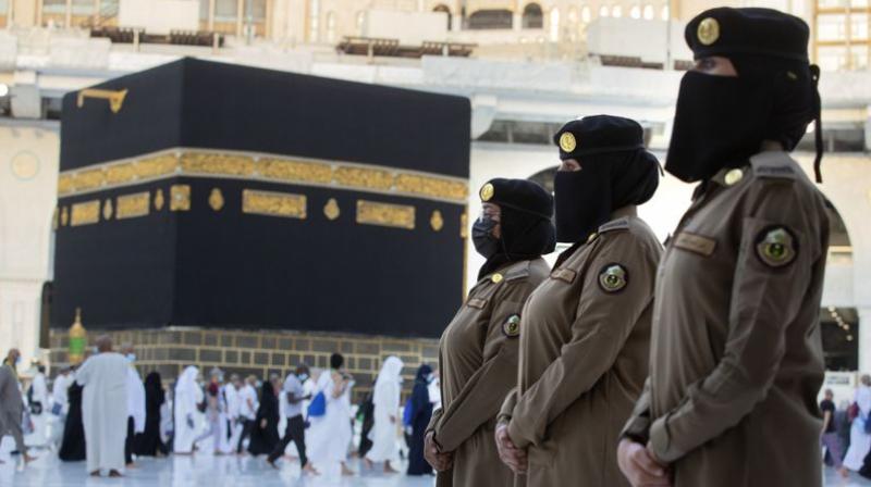 Saudi police women, who are recently deployed to the service, stand alert in front of the Kaaba, the cubic building at the Grand Mosque, during the annual hajj pilgrimage, in Saudi Arabias holy city of Mecca. (AP)