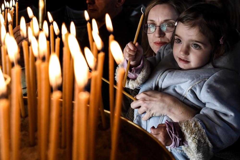Orthodox Ukrainians flock to churches around the country this week to celebrate Easter, the country's foremost religious celebration. (Photo: AFP) Orthodox Ukrainians flock to churches around the country this week to celebrate Easter, the country's foremost religious celebration. (Photo: AFP)