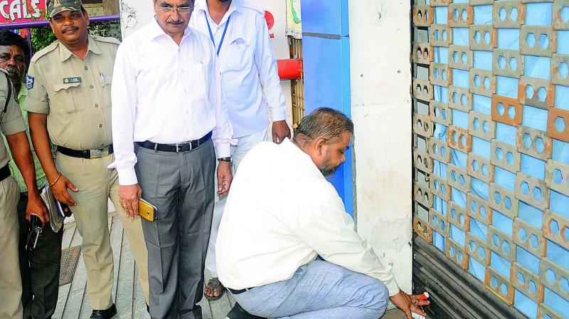 Health department officials seal the Sraddha Hospital that is facing charges of being involved in kidney transplantation racket, in Visakhapatnam on Saturday. — DC Health department officials seal the Sraddha Hospital that is facing charges of being involved in kidney transplantation racket, in Visakhapatnam on Saturday. — DC