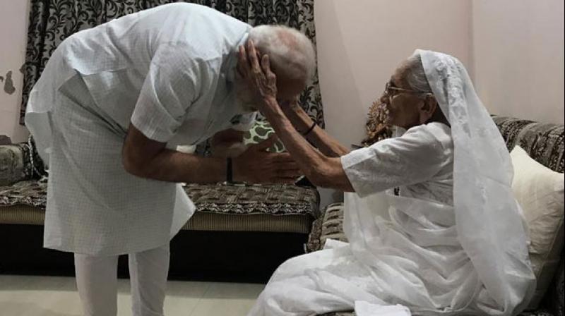 Four days before taking oath as Prime Minister for a second term, Narendra Modi on Sunday visited his mother Heeraben Modi to seek her blessings. (Photo: ANI) Four days before taking oath as Prime Minister for a second term, Narendra Modi on Sunday visited his mother Heeraben Modi to seek her blessings. (Photo: ANI)