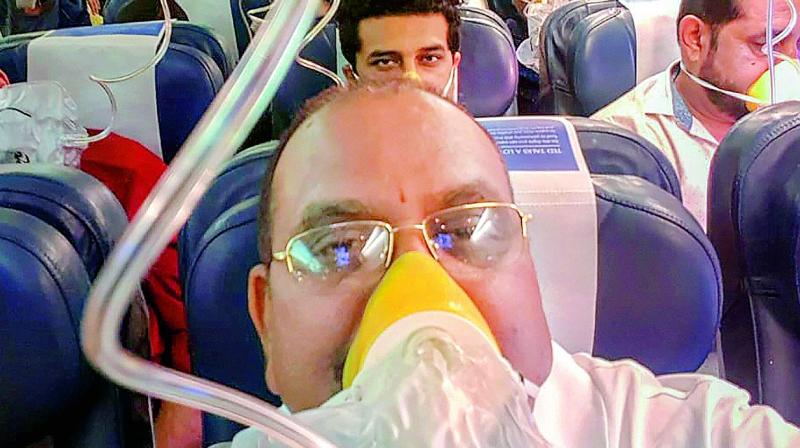 Passengers on board the Mumbai-Jaipur Jet Airways flight wear oxygen masks during an emergency after cabin pressure drop, in Mumbai, Thursday. (Photo: PTI) Passengers on board the Mumbai-Jaipur Jet Airways flight wear oxygen masks during an emergency after cabin pressure drop, in Mumbai, Thursday. (Photo: PTI)