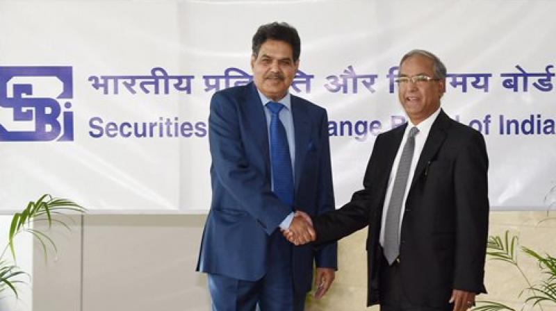 Newly appointed SEBI Chairman, Ajay Tyagi is greeted by the outgoing chairman, U K Sinha as he assumes charge at the SEBI headquarters in Mumbai. (Photo: PTI) Newly appointed SEBI Chairman, Ajay Tyagi is greeted by the outgoing chairman, U K Sinha as he assumes charge at the SEBI headquarters in Mumbai. (Photo: PTI)