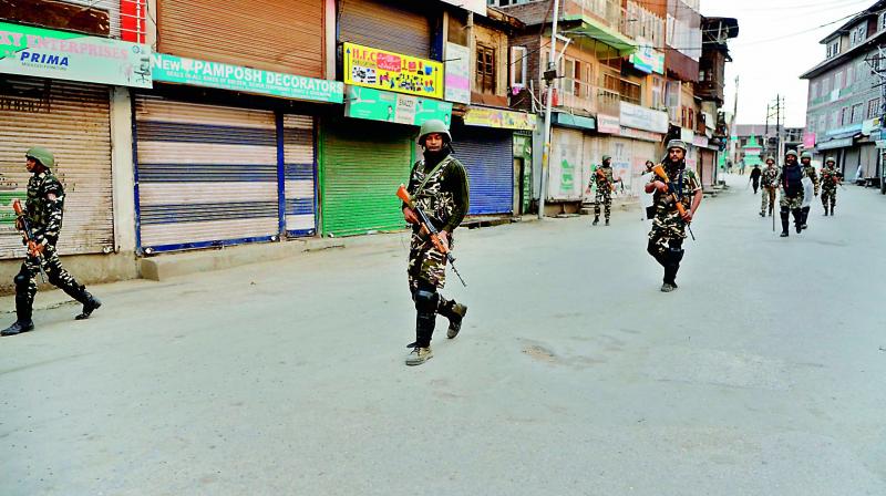 Security personnel patrol along a street in Srinagar as widespread restrictions on movement and a telecommunications blackout remained in place. (AFP) Security personnel patrol along a street in Srinagar as widespread restrictions on movement and a telecommunications blackout remained in place. (AFP)