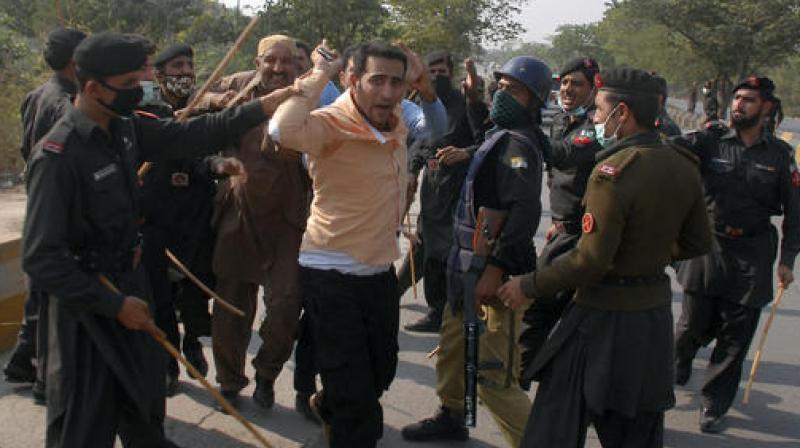 Pakistani security officers arrest supporters of opposition politician Imran Khan who were trying to reach Khan's house, in Islamabad, Pakistan. (Photo: AP) Pakistani security officers arrest supporters of opposition politician Imran Khan who were trying to reach Khan's house, in Islamabad, Pakistan. (Photo: AP)