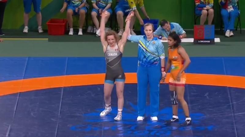 Babita Kumari(right) in orange was being out-manoeuvred by Canada's Diana Weicker in the summit clash. (Photo: Twitter / IOA) Babita Kumari(right) in orange was being out-manoeuvred by Canada's Diana Weicker in the summit clash. (Photo: Twitter / IOA)