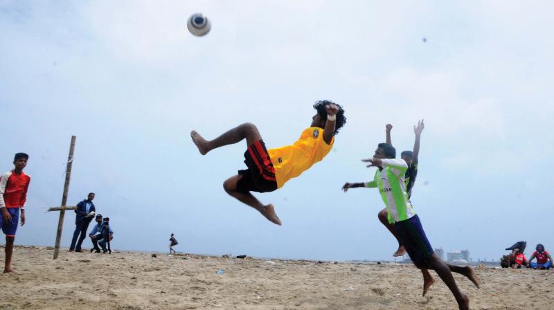 Young guys play football on the beach. (Photo: DC) Young guys play football on the beach. (Photo: DC)