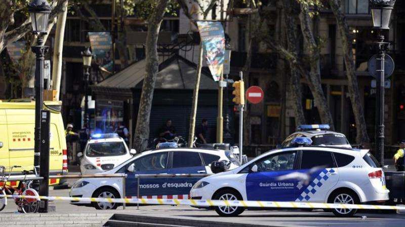 Policemen stand next to vehicles in a cordoned off area after a van ploughed into the crowd, injuring several persons on the Rambla in Barcelona on August 17, 2017. (Photo: AFP) Policemen stand next to vehicles in a cordoned off area after a van ploughed into the crowd, injuring several persons on the Rambla in Barcelona on August 17, 2017. (Photo: AFP)