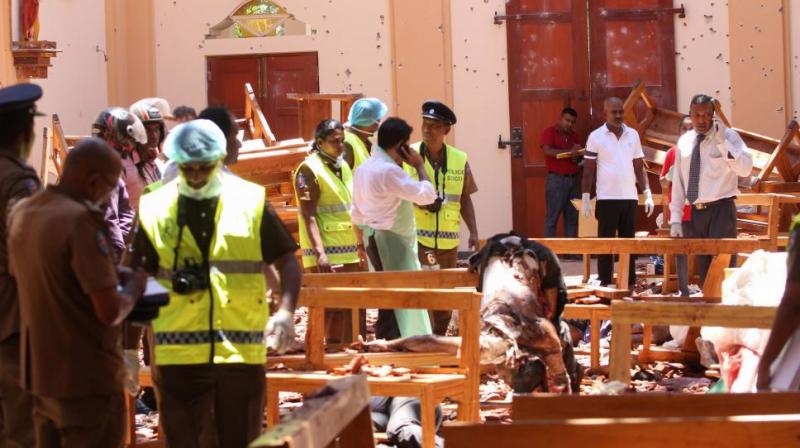 Sri Lankan security personnel walk past debris next to a dead body slumped over a bench following an explosion in St Sebastian's Church in Negombo, north of the capital Colombo, on April 21, 2019. (Photo: AFP) Sri Lankan security personnel walk past debris next to a dead body slumped over a bench following an explosion in St Sebastian's Church in Negombo, north of the capital Colombo, on April 21, 2019. (Photo: AFP)