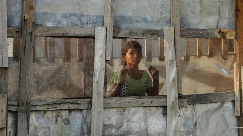In this August 16, 2017 photo, a Rohingya refugee girl looks through a mesh window at a camp set up for the refugees on the outskirts of Jammu. (Photo: AP) In this August 16, 2017 photo, a Rohingya refugee girl looks through a mesh window at a camp set up for the refugees on the outskirts of Jammu. (Photo: AP)
