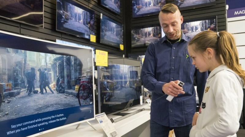 In this photo taken Saturday, April 15, 2017, Salome Sigurjonsdottir, 10, tests a voice-controlled television in an electronics store in Reykjavik. Sales assistant Einar Dadi said none of his TVs understood Icelandic. The revered Icelandic language, seen by many as a source of identity and pride, is being undermined by the widespread use of English both for mass tourism and in the voice-controlled artificial intelligence devices coming into vogue. (AP Photo/Egill Bjarnason) In this photo taken Saturday, April 15, 2017, Salome Sigurjonsdottir, 10, tests a voice-controlled television in an electronics store in Reykjavik. Sales assistant Einar Dadi said none of his TVs understood Icelandic. The revered Icelandic language, seen by many as a source of identity and pride, is being undermined by the widespread use of English both for mass tourism and in the voice-controlled artificial intelligence devices coming into vogue. (AP Photo/Egill Bjarnason)