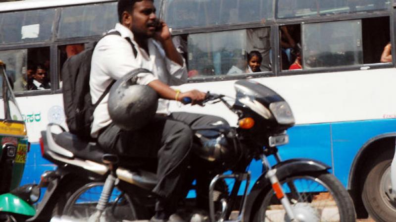 A traffic policeman gives a woman a free helmet as part of an initiative for World Head Injury Day. (Photo: PTI/Representational) A traffic policeman gives a woman a free helmet as part of an initiative for World Head Injury Day. (Photo: PTI/Representational)
