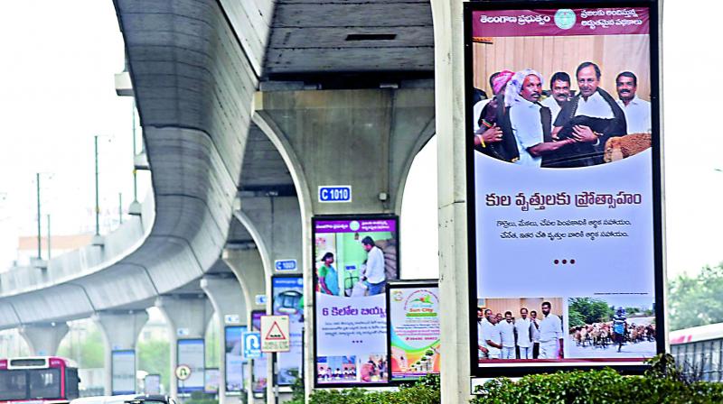 Banners of welfare schemes taken up by the Telangana state government have come up all over the city, on Metro pillars, bridges and bus shelters (Photo: DC0 Banners of welfare schemes taken up by the Telangana state government have come up all over the city, on Metro pillars, bridges and bus shelters (Photo: DC0
