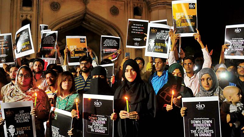 Students of Islamic Organizations (SIO) hold placards during a candle light vigil to protest the Kathua and Unnao rape cases in Hyderabad on Saturday (Photo: File/AP Students of Islamic Organizations (SIO) hold placards during a candle light vigil to protest the Kathua and Unnao rape cases in Hyderabad on Saturday (Photo: File/AP
