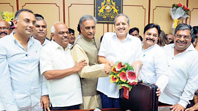 KPCC President Dinesh Gundurao, Speaker Ramesh Kumar and pro-tem chairman of the legislative Council Basavaraj Horatti with newly-elected MLCs U.B. Venkatesh, Naseer Ahmed and Prakash Rathod after the swearing-in ceremony in Bengaluru on Monday (Image DC) KPCC President Dinesh Gundurao, Speaker Ramesh Kumar and pro-tem chairman of the legislative Council Basavaraj Horatti with newly-elected MLCs U.B. Venkatesh, Naseer Ahmed and Prakash Rathod after the swearing-in ceremony in Bengaluru on Monday (Image DC)