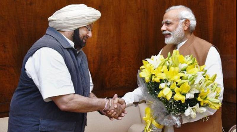 Punjab Chief Minister Amarinder Singh calling on Prime Minister Narendra Modi at Parliament House in New Delhi on Wednesday. (Photo: PTI) Punjab Chief Minister Amarinder Singh calling on Prime Minister Narendra Modi at Parliament House in New Delhi on Wednesday. (Photo: PTI)